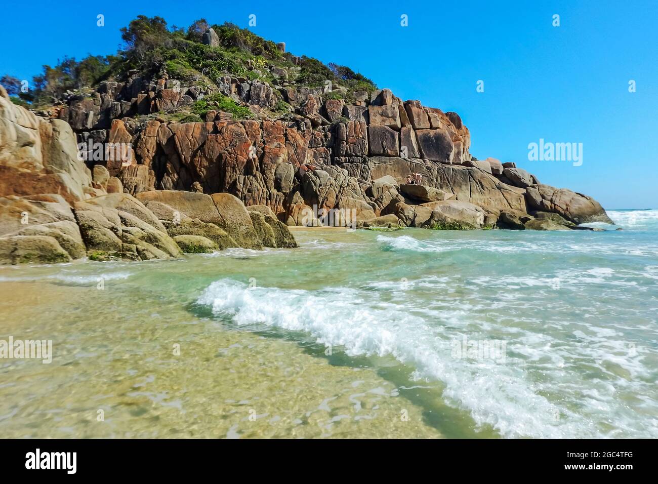 a rocky island in the middle of a body of water Stock Photo