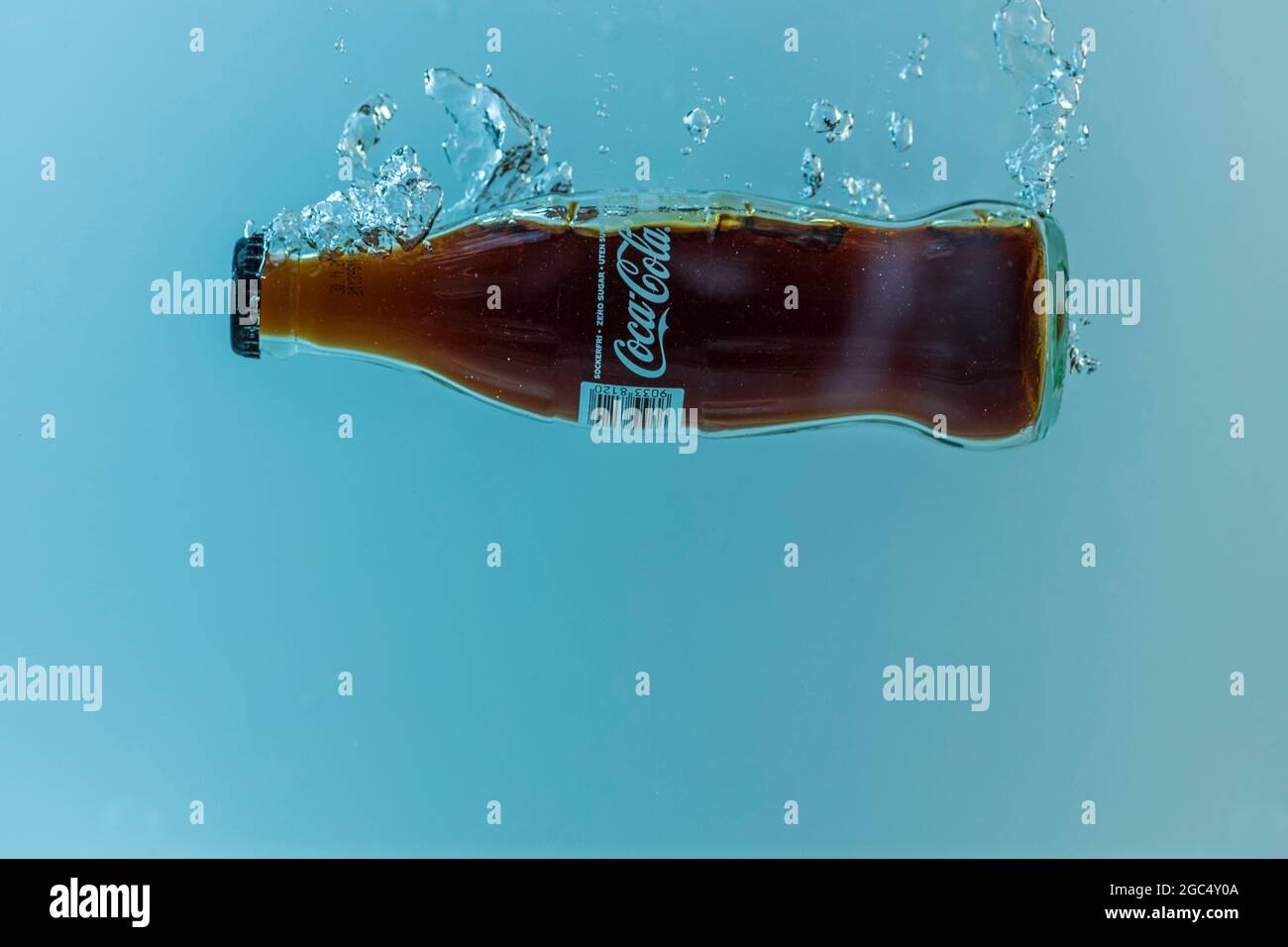 Close up view of Coca cola bottle falling in water Stock Photo Alamy