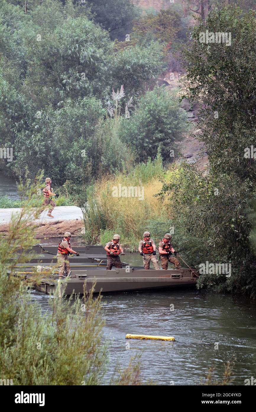 National Guardsmen build temporary bridge across waterway during firefighting. Stock Photo