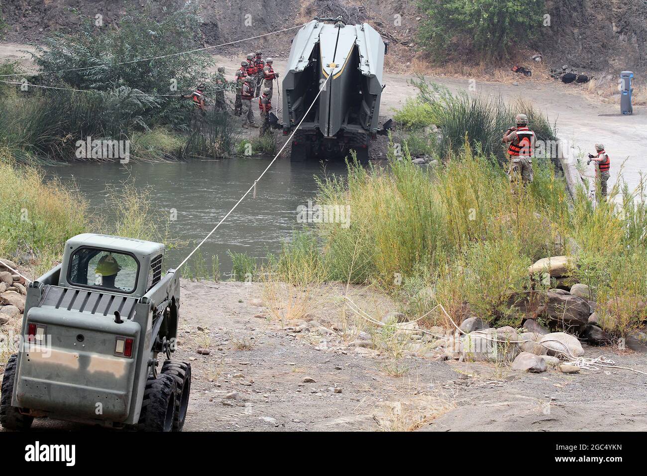National Guardsmen build temporary bridge across waterway during firefighting. Stock Photo