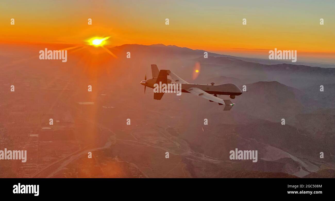 An MQ-9 Reaper remotely piloted aircraft flown by 163d Attack Wing pilot Lt. Col. Paul Brockmeier, with sensor operator Master Sgt. Anthony Martinez, views the smoky San Gabriel Mountains of southern California in transit to a fire mission in northern California, late August, 2020.  “The beauty of the sunsets doesn’t begin to mitigate the tragedy of the fires,” said Brockmeier. “But it’s always a beautiful evening when you’re flying to the aid of your fellow Californians.”  (Photo courtesy of Chalk 2 for the 163d Attack Wing) Stock Photo