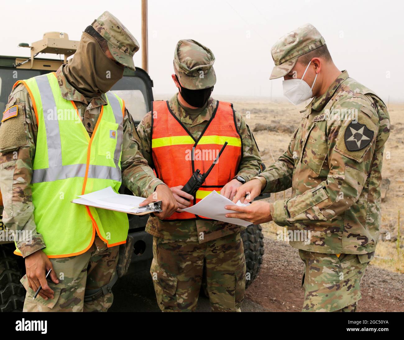 Oregon Army National Guard Spc. Russell Baghdadi, Staff Sgt. Randy Bowman and 2nd Lt. Sky Smith, all with 1st squadron, 82nd Cavalry Regiment, work together to review resident rosters at a traffic control point (TCP), Warm Springs, Ore., Sept. 17, 2020. The Lionshead Fire, located 14-miles west of Warm Springs, could potentially lead to an evacuation, leaving homes vulnerable. Soldiers from 82nd Cavalry Regiment, stationed at four TCPs along U.S. Highway 26, help reassure local citizens and monitor anyone who enters and exits the neighborhoods. Stock Photo