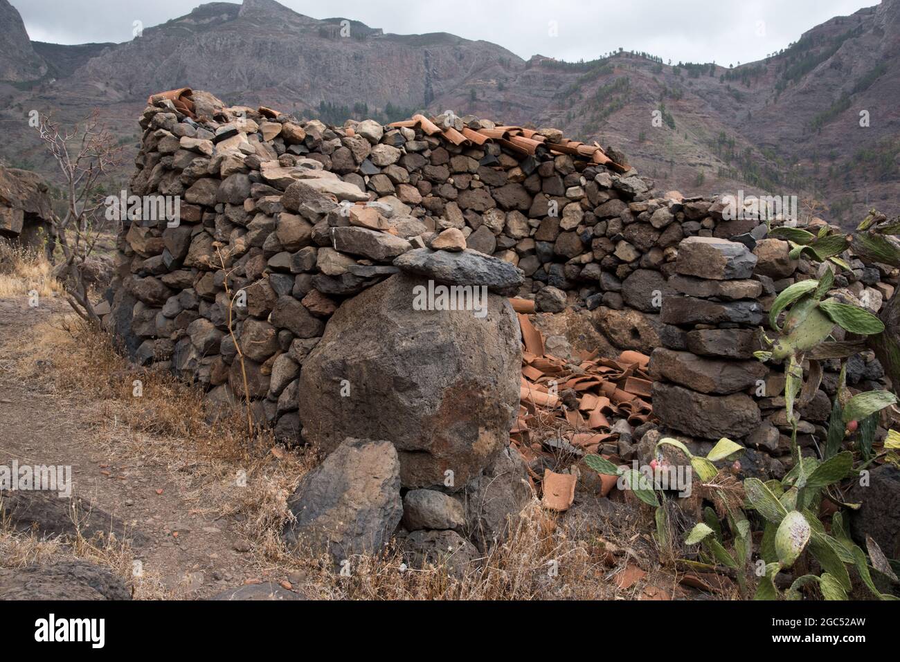 Small villages like Benchijigua at  La Gomera in the Canary Island have lots of ruins of Canarian Island houses built from lava rock. Stock Photo