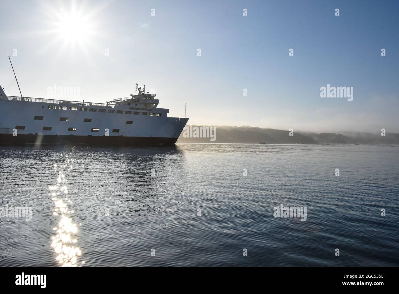 Ferryboat coming into the harbor as the morning fog burns off.  Port Jefferson, New York.  Copy space. Stock Photo