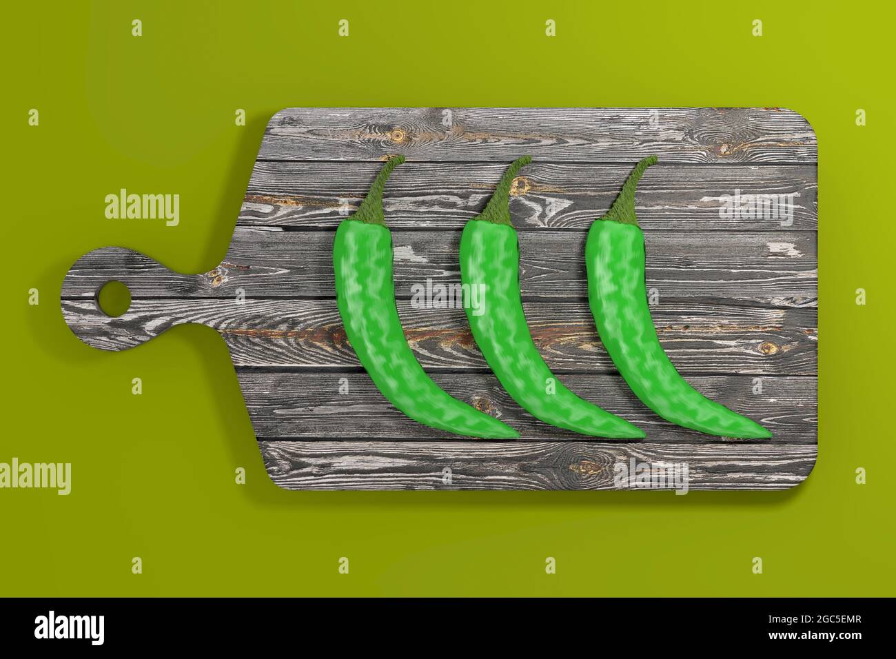 Three Green Hot Chili Peppers over Wooden Cutting Board on a green ...