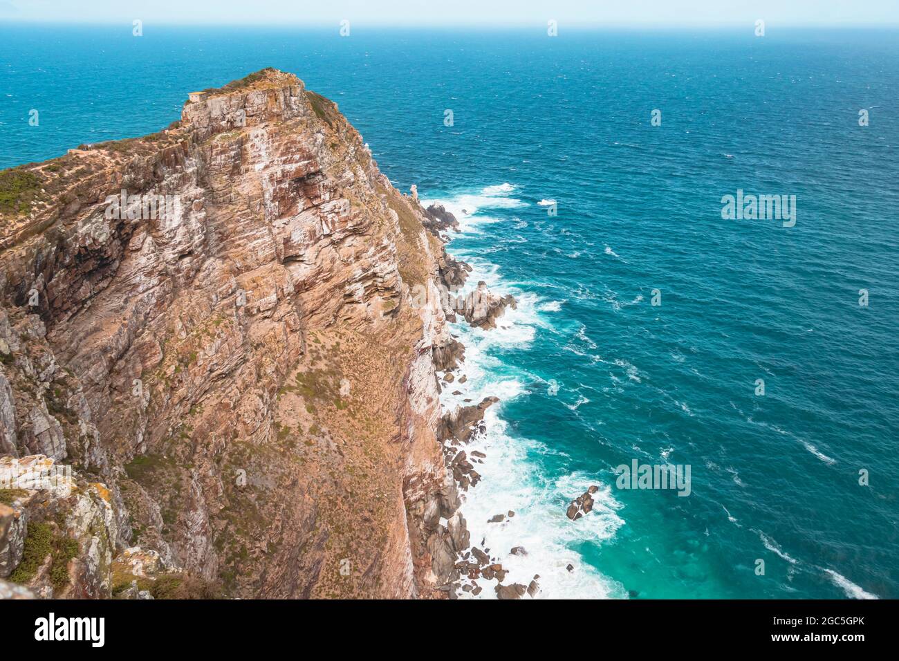 The view of rock headland above the Atlantic Ocean at Cape Point, a mountainous promontory of Cape Point National Park in Cape Peninsula, South Africa. Stock Photo