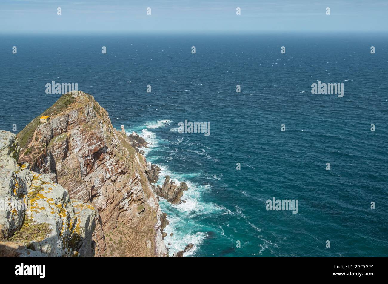 The view of rock headland above the Atlantic Ocean at Cape Point, a mountainous promontory of Cape Point National Park in Cape Peninsula, South Africa. Stock Photo