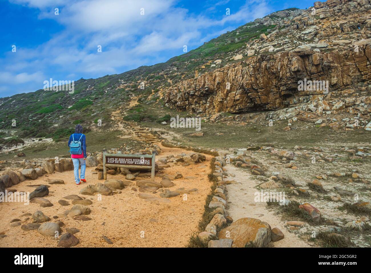 A woman at the trail of Cape of Good Hope scenic walk in Cape Point National Park, South Africa. Stock Photo