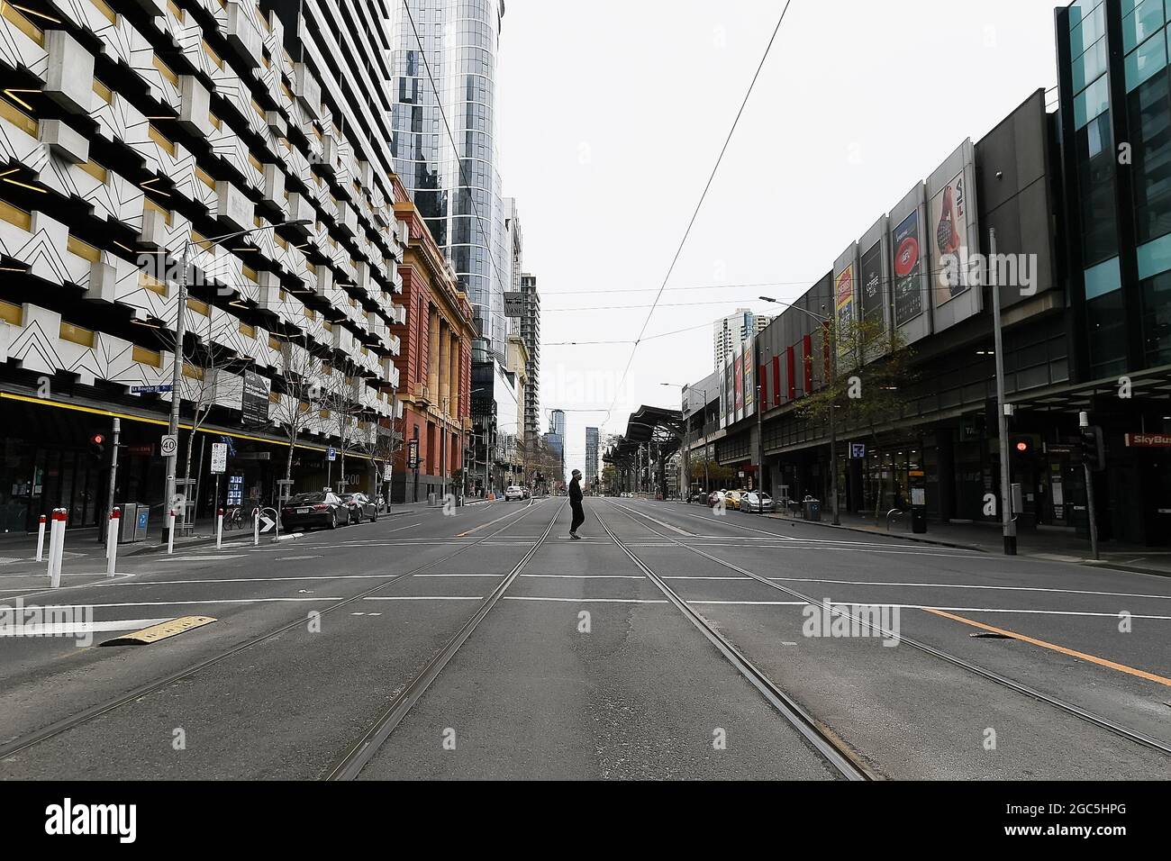 Melbourne, Australia, 7 August, 2021. A man walks across a deserted Spencer Street on the first weekend of Melbourne's sixths lockdown COVID-19 lockdown that has been placed on the State of Victoria. Credit: Michael Currie/Speed Media/Alamy Live News Stock Photo