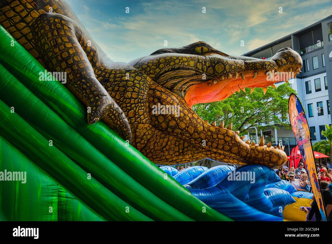 A gathered crowd around the colourful crocodile slide at the opening of the new Esplanade presinct in Cairns, Queensland, Australia. Stock Photo
