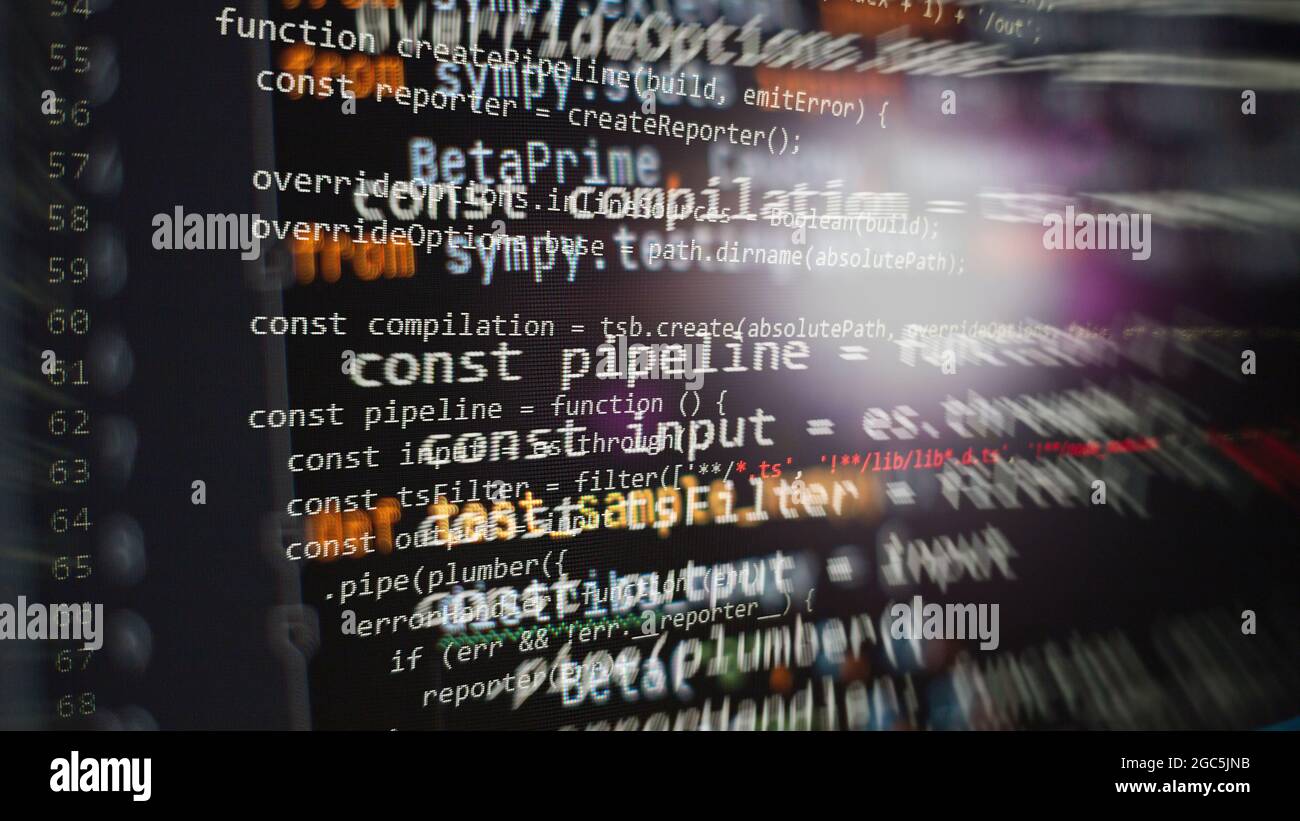 Hacker background, Programmer working in desktop laptop, Blurred screen with selective focus, JS, Closeup cooperating in web specialist apps, Tech sou Stock Photo