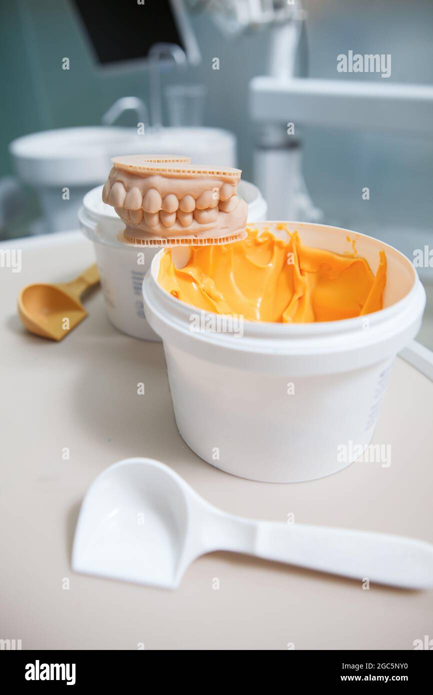 Vertical close up of jars with dental putty at dentist office Stock