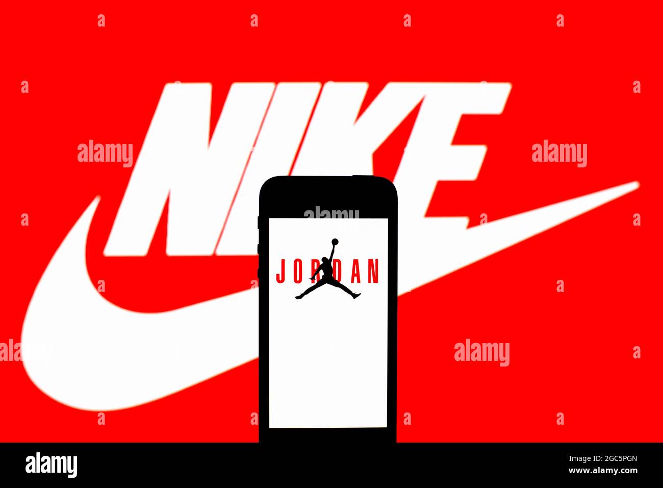 Spain. 06th Aug, 2021. In this photo illustration, an Air Jordan logo seen  displayed on a smartphone and in the background. Credit: SOPA Images  Limited/Alamy Live News Stock Photo - Alamy