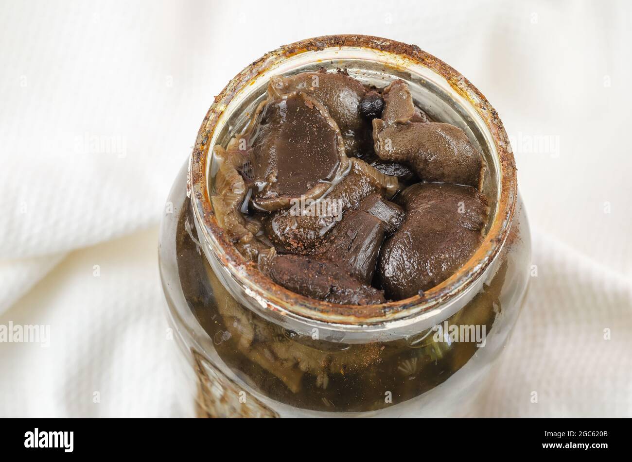 Botulism, food poisoning from canned foods concept. Opened Glass jar