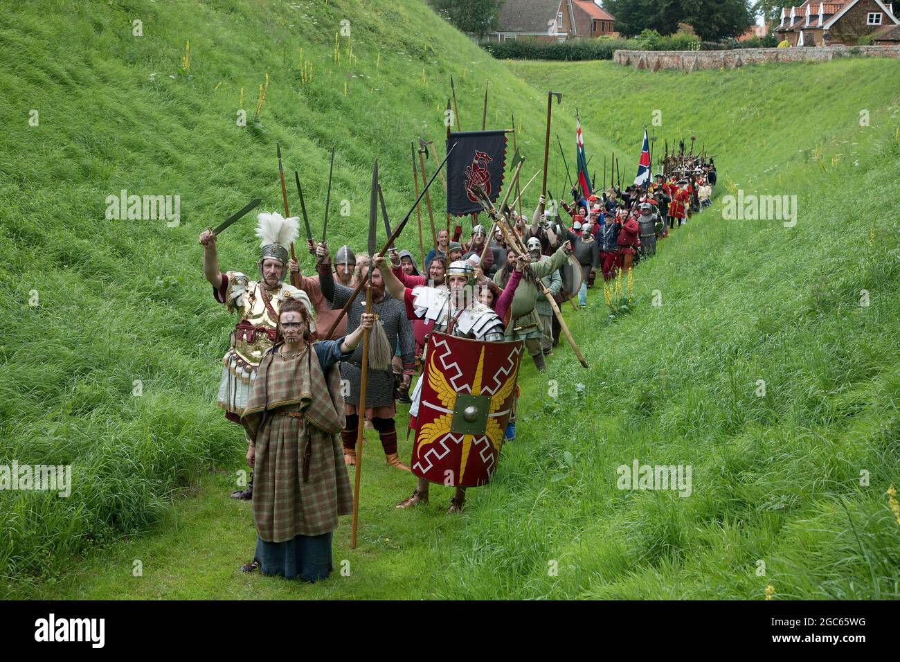 1st August 2021. Norfolk, England. Soldiers Through the Ages event at Castle Rising, the first public event at the 12th Century castle since before the Covid pandemic outbreak.  Led by Queen Boudica, a parade of re-enactors around the castle's moat, representing warriors from Roman Britain through to the two world wars. Stock Photo