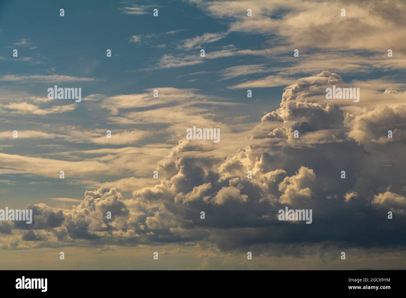 Cumulus clouds against a blue sky Stock Photo - Alamy