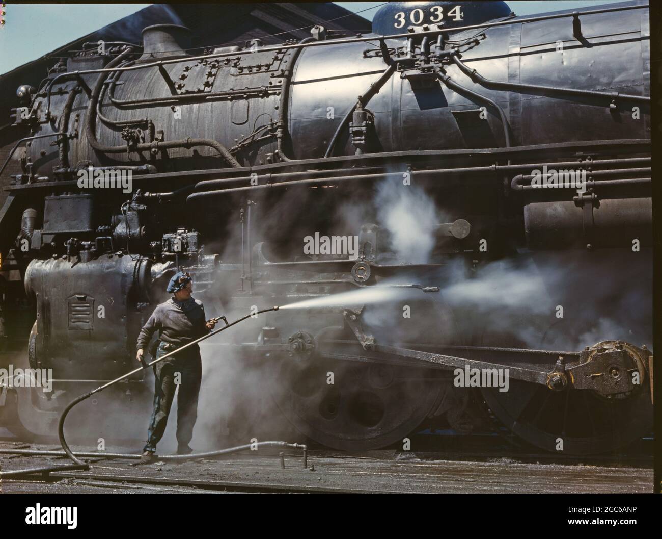 American railroads in color 1939 Mrs Viola Sievers steam cleaning H class locomotive at Clinton Iowa Stock Photo