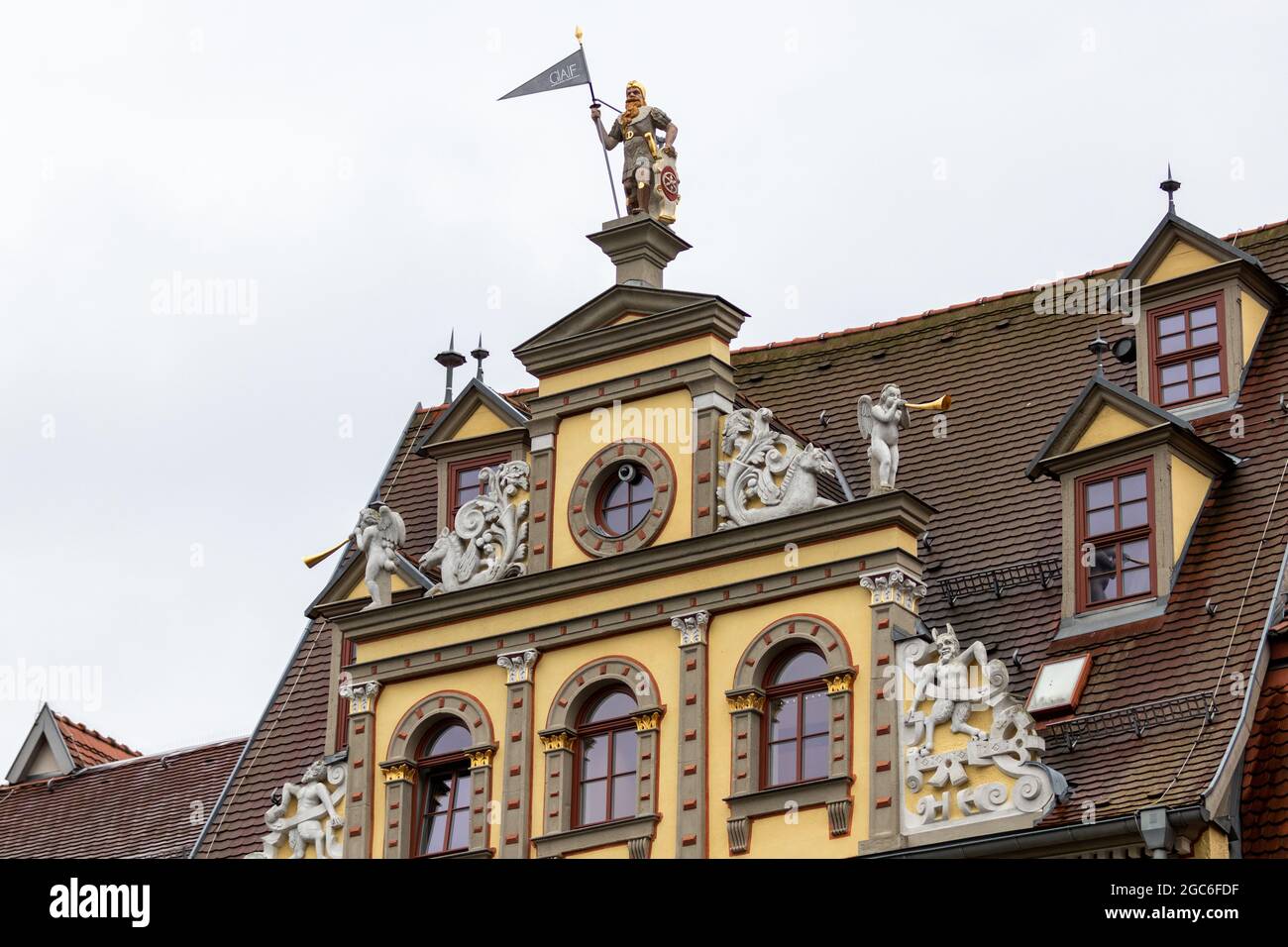 Facade of a historic building on the fish market in Erfurt with a sculpture of a warrior on top Stock Photo