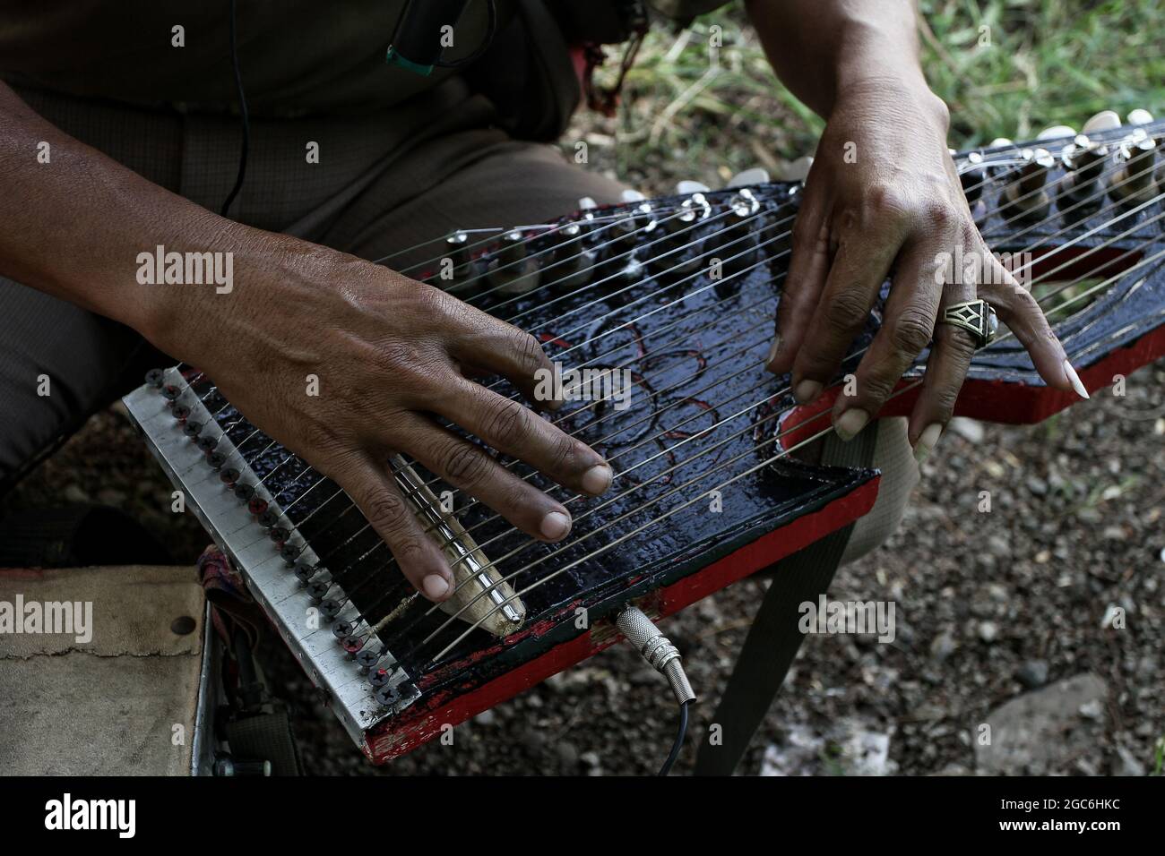 Bandung, West Java, Indonesia. Plays the Kacapi musical instrument which is a Sundanese art musical instrument. Stock Photo