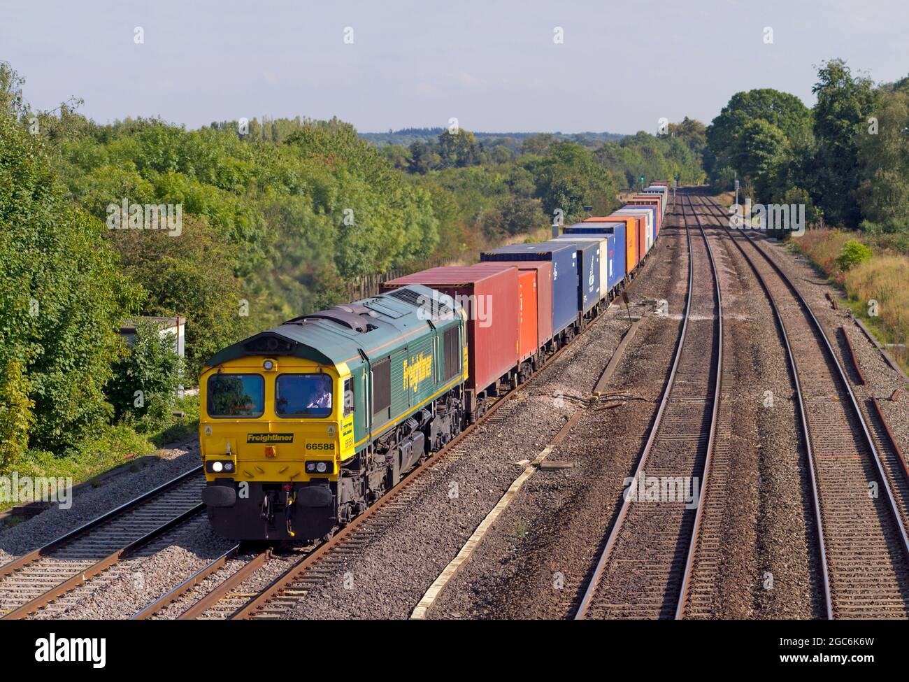 A Class 66 diesel locomotive number 66588 working a well loaded freightliner along the Great Western Mainline at Lower Basildon. Stock Photo