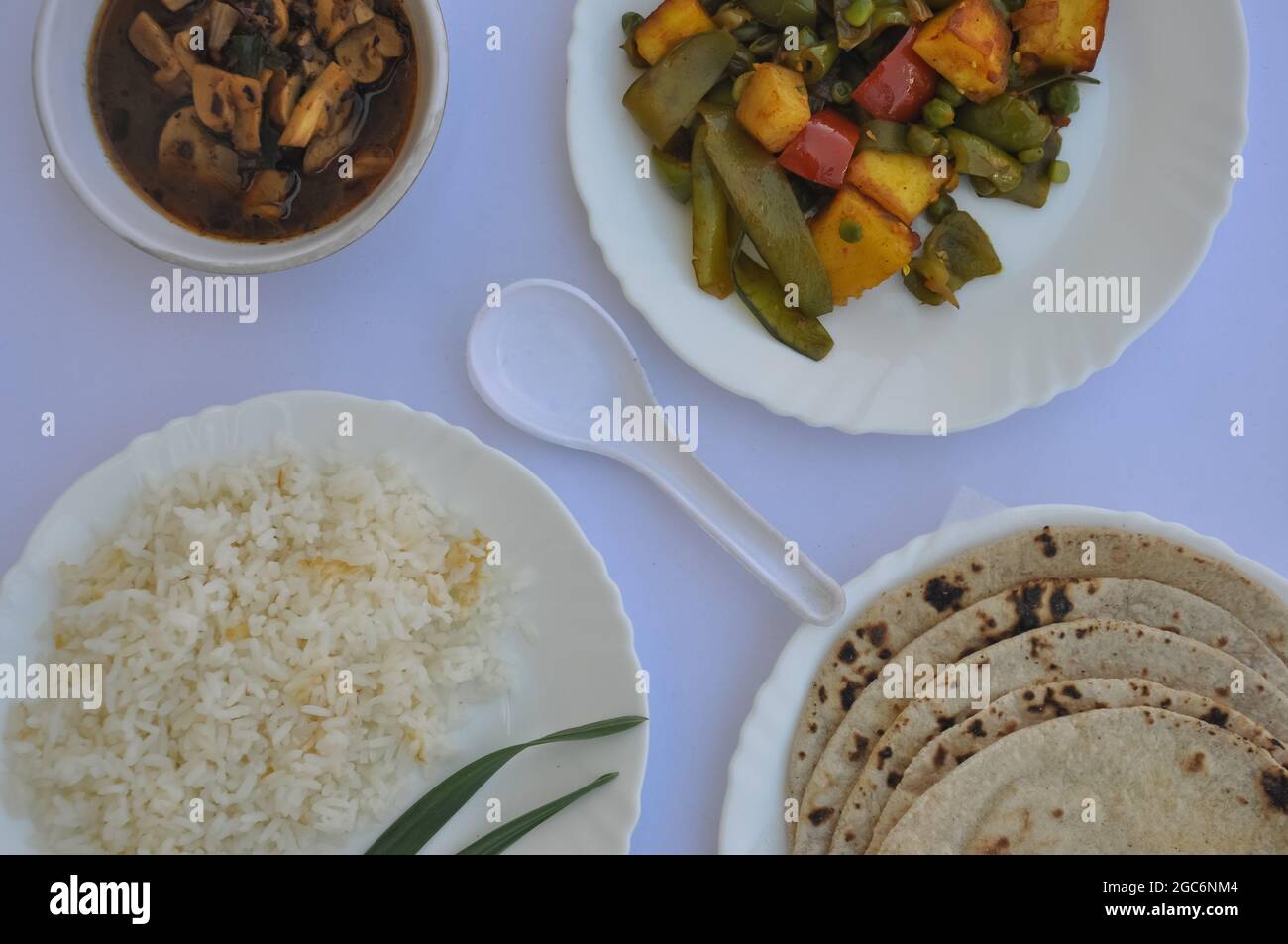 Top view of matar paneer veg, mashroom soup, roti (chapati) and rice (Indian food) isolated over white background Stock Photo