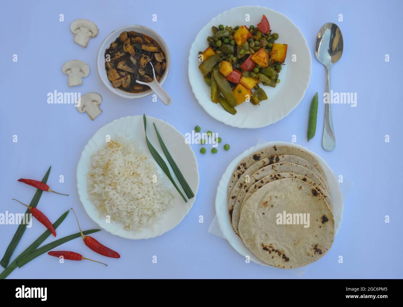 Top view of matar paneer veg, mashroom soup, roti (chapati) and rice (Indian food) isolated over white background Stock Photo