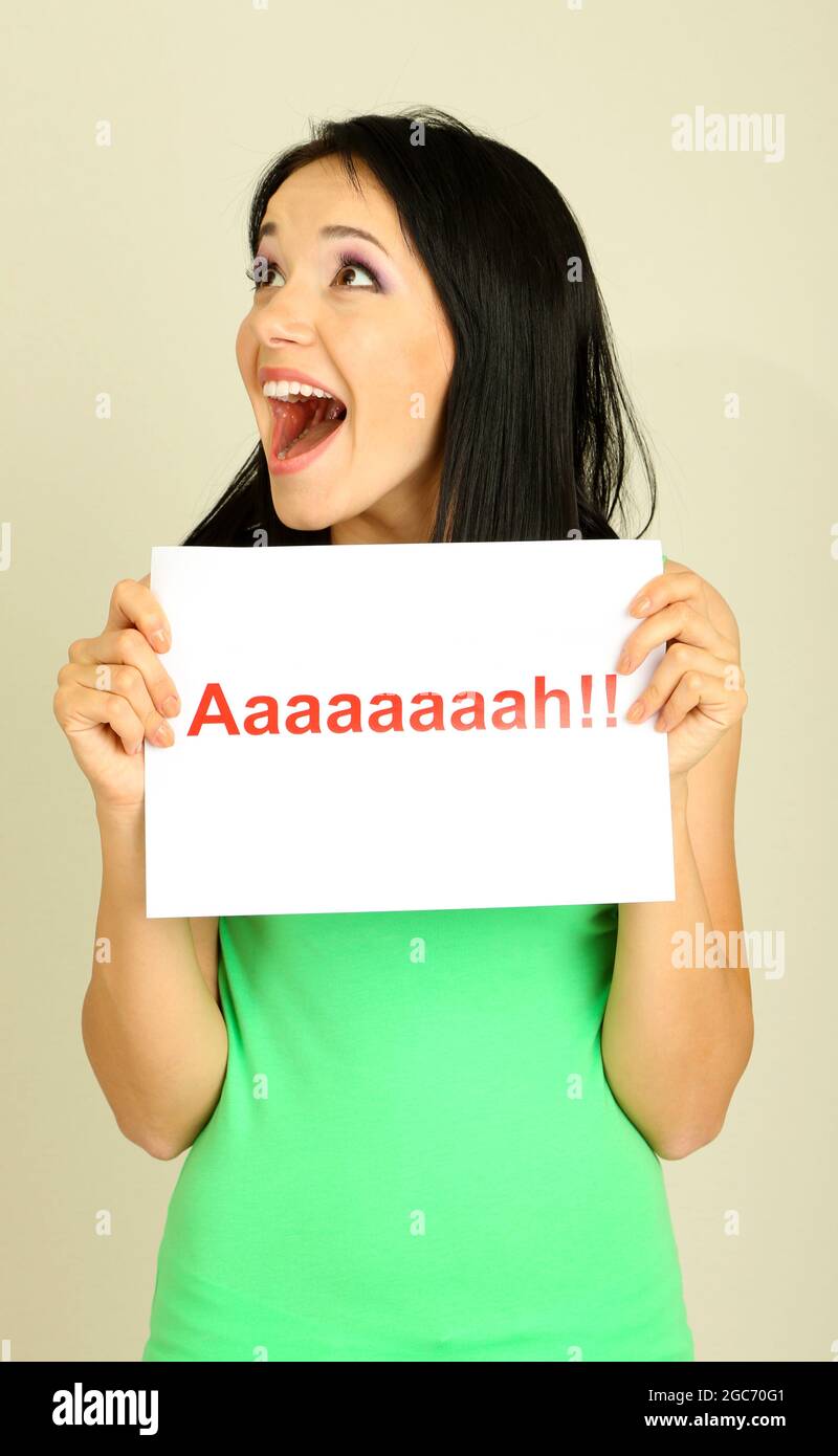 Surprised young woman holds inscription 