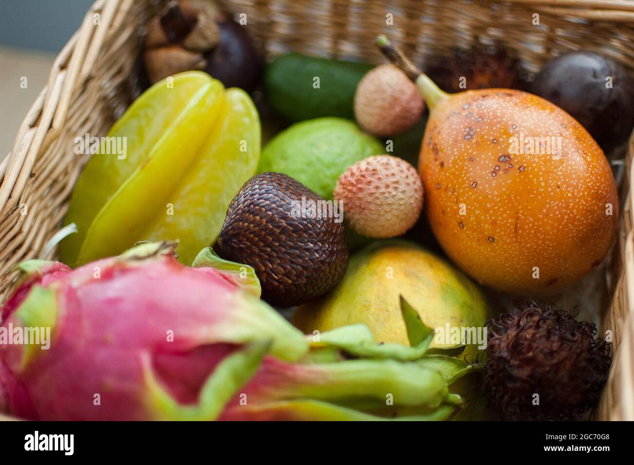 Big basket of fresh tropical fruits, passion fruit, carambola, dragon