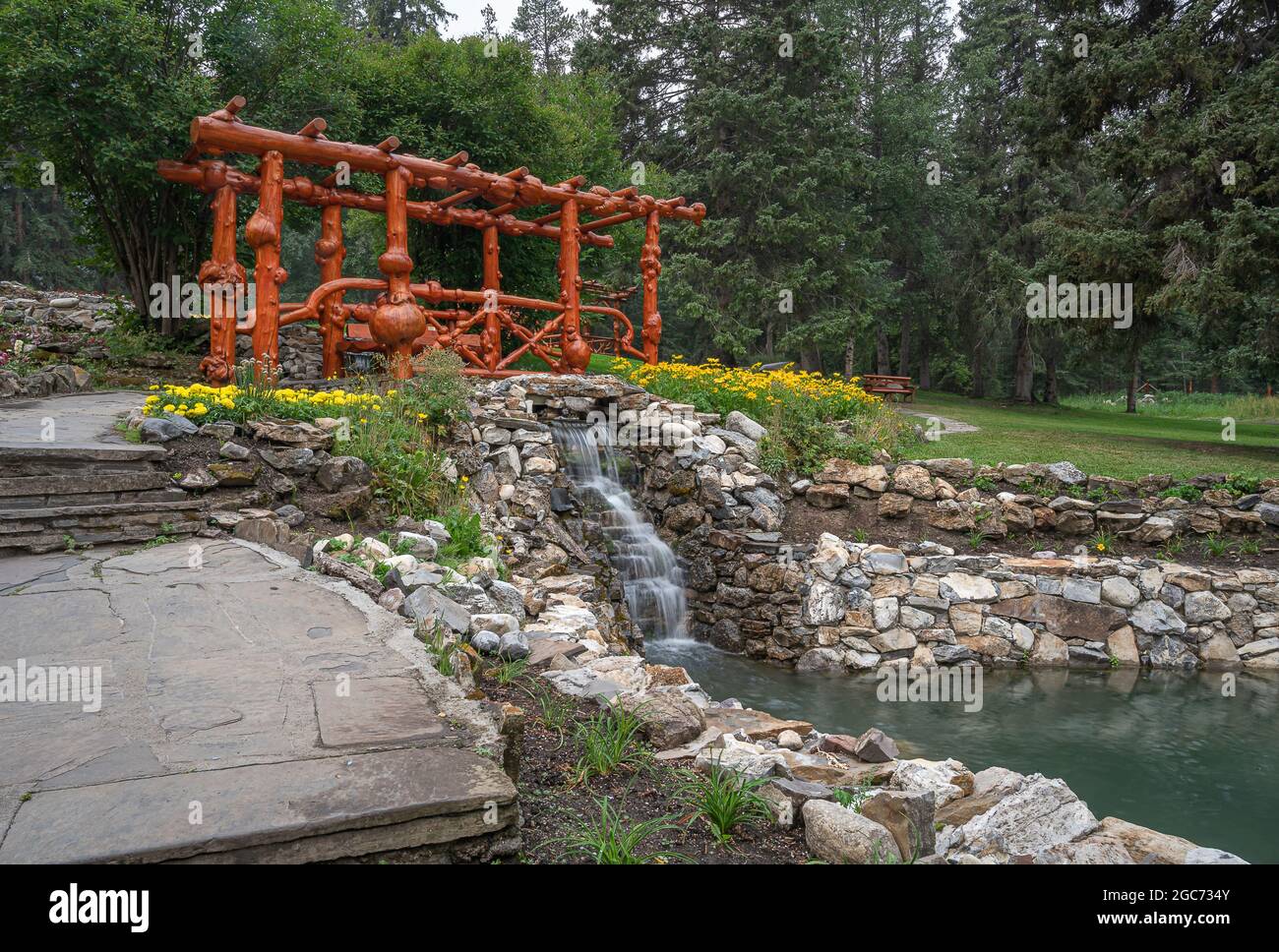 A bridge made from burled logs in Cascade public gardens in Banff, Alberta, Canada Stock Photo