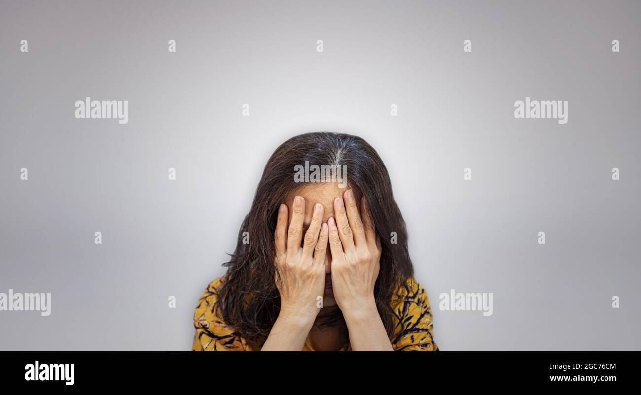 Elder Woman Covering Her Face By Hands Stock Photo - Alamy