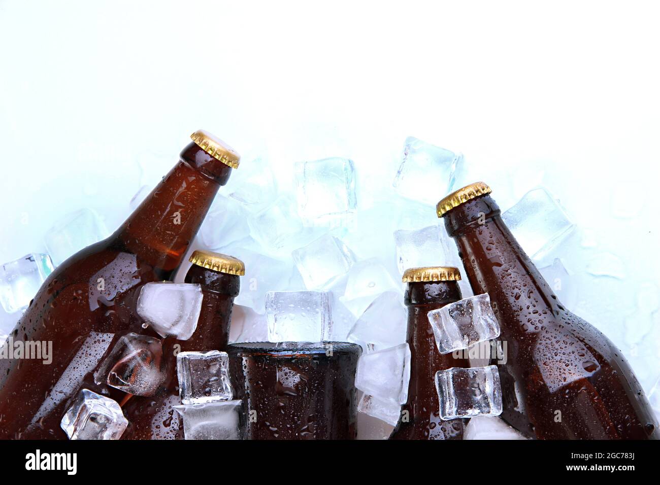 Beer bottles in ice cubes close up Stock Photo Alamy