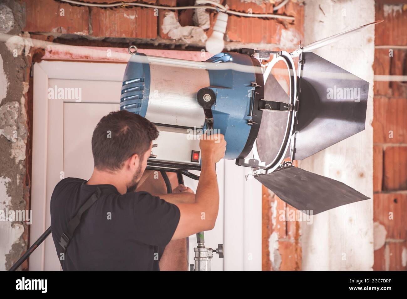 Behind the scene. Filmmaking lighting technician electric engineer