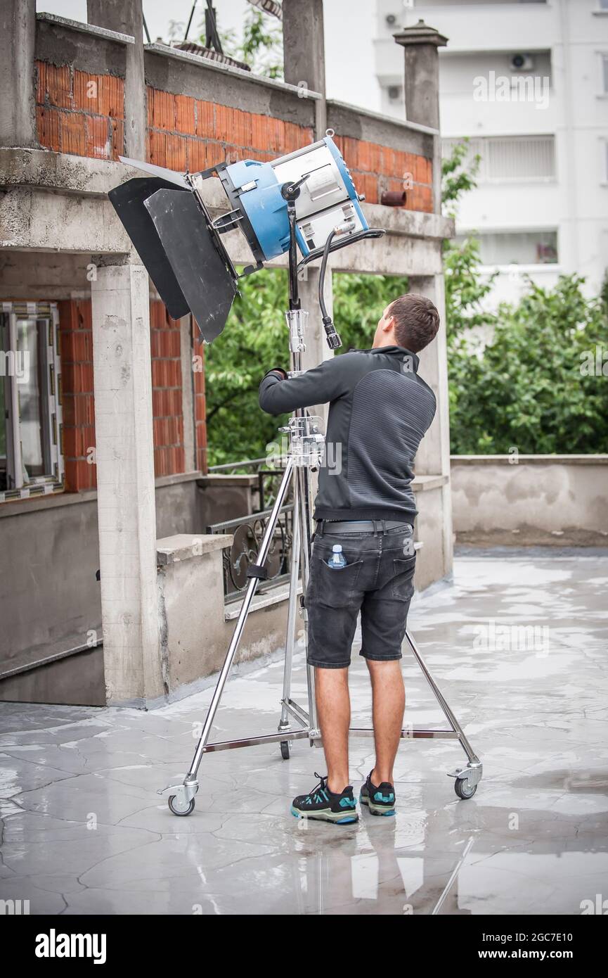 Behind the scene. Filmmaking lighting technician electric engineer