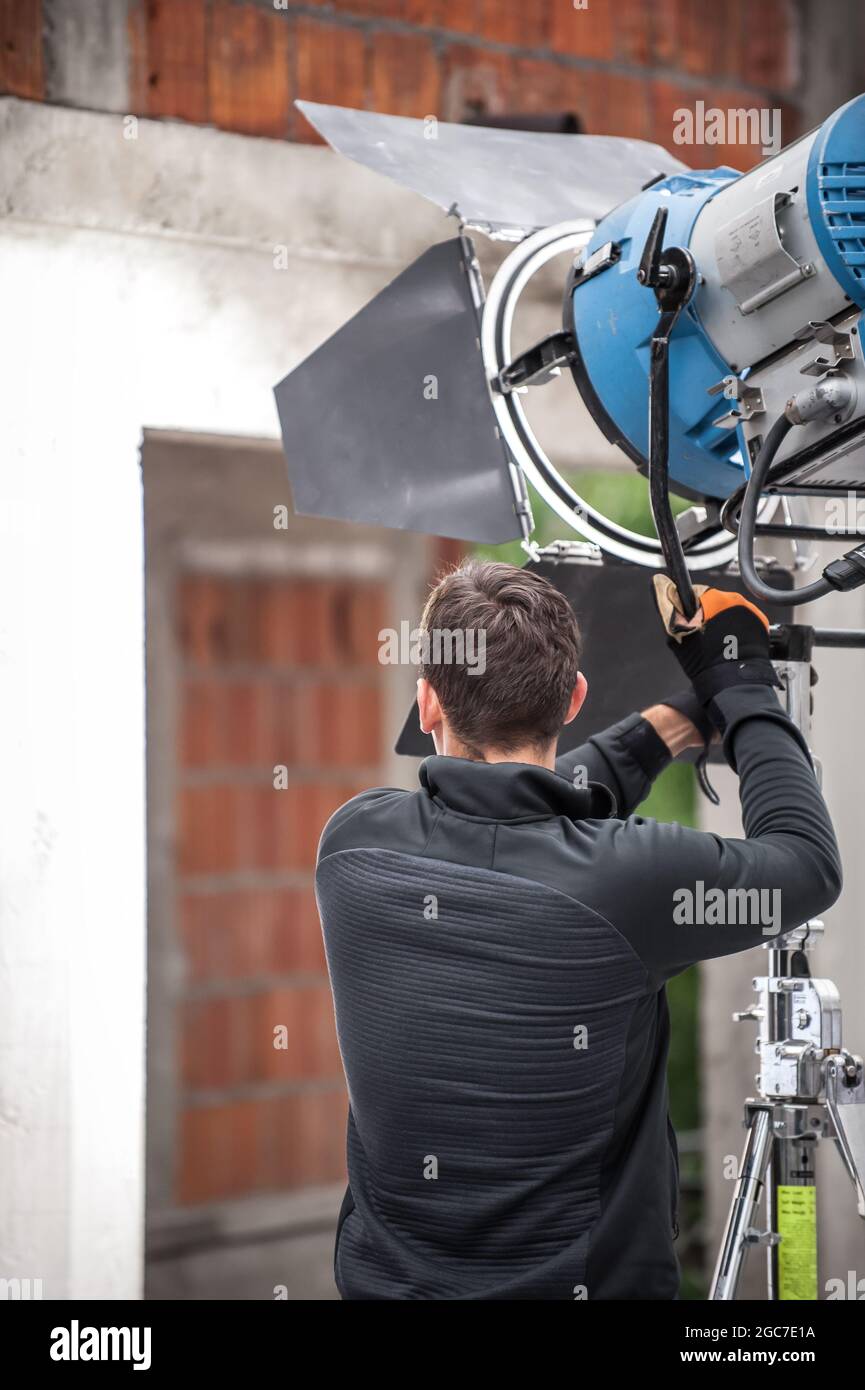 Behind the scene. Filmmaking lighting technician electric engineer