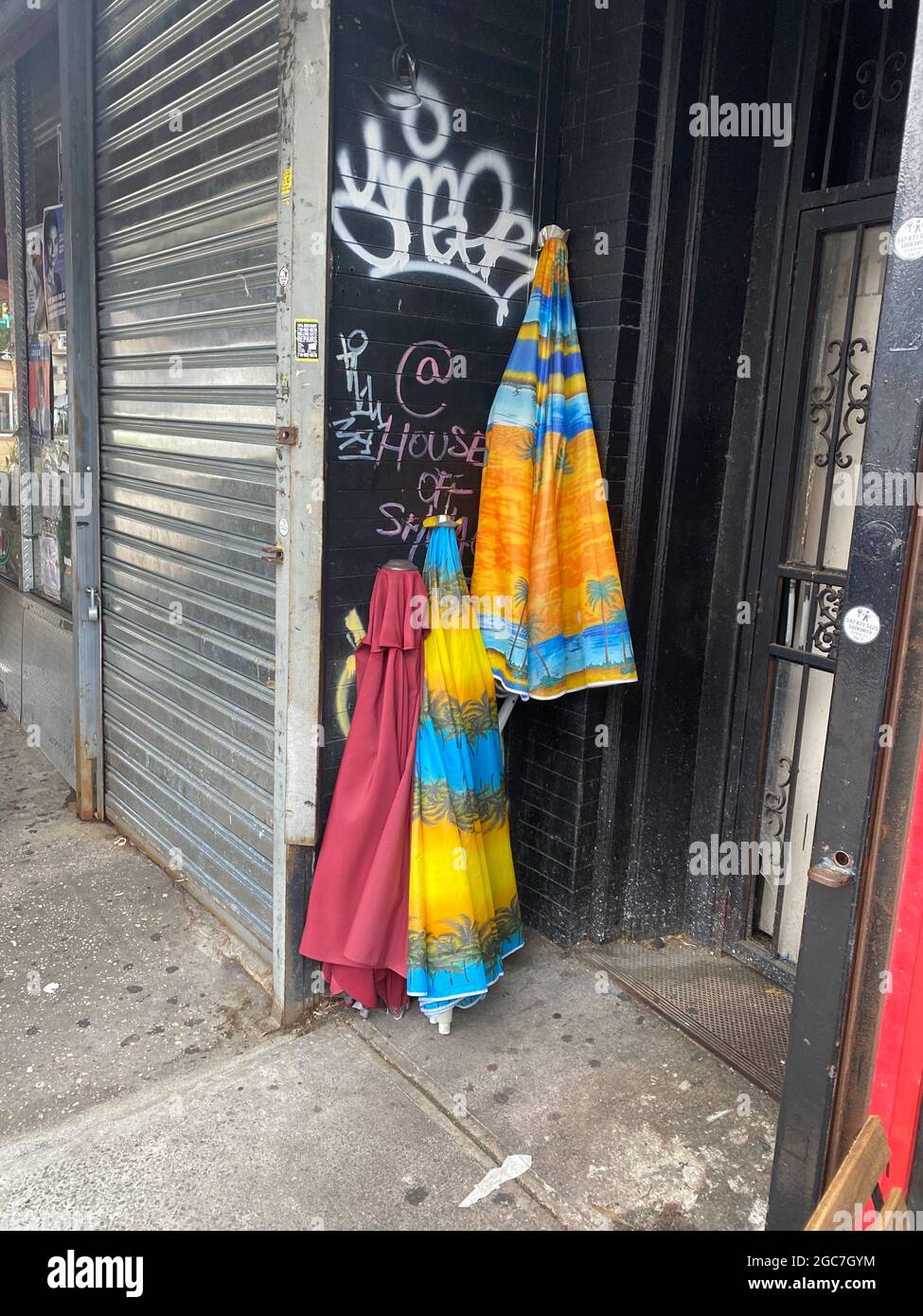 Colorful beach umbrellas outside an apartment building entrance. Stock Photo