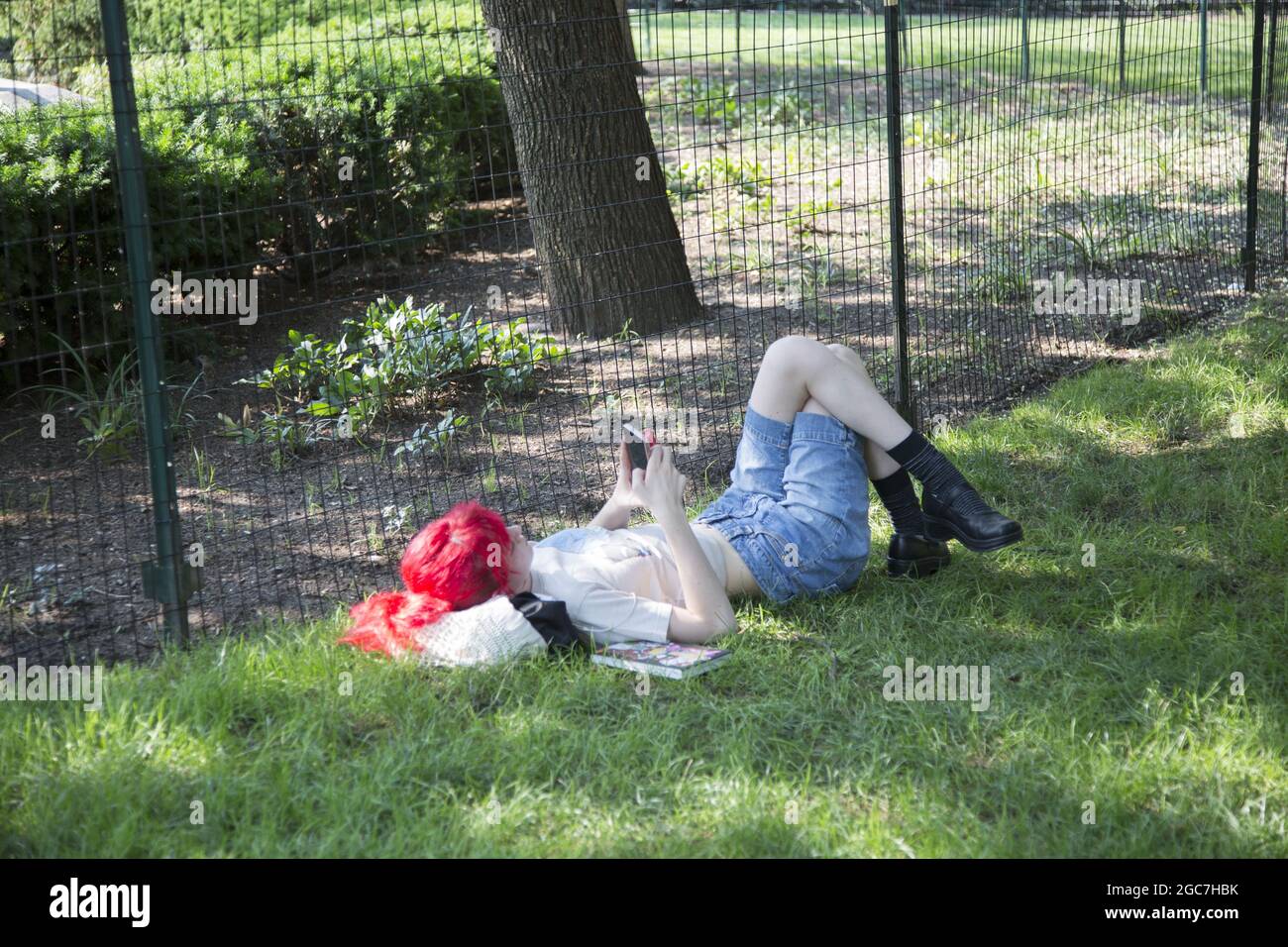 Young woman relaxes in Union Square Park in Manhattan, New York City. Stock Photo