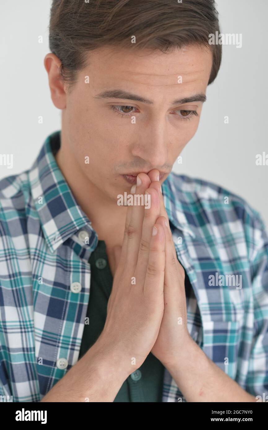 Stylish man praying in studio hi-res stock photography and images - Alamy