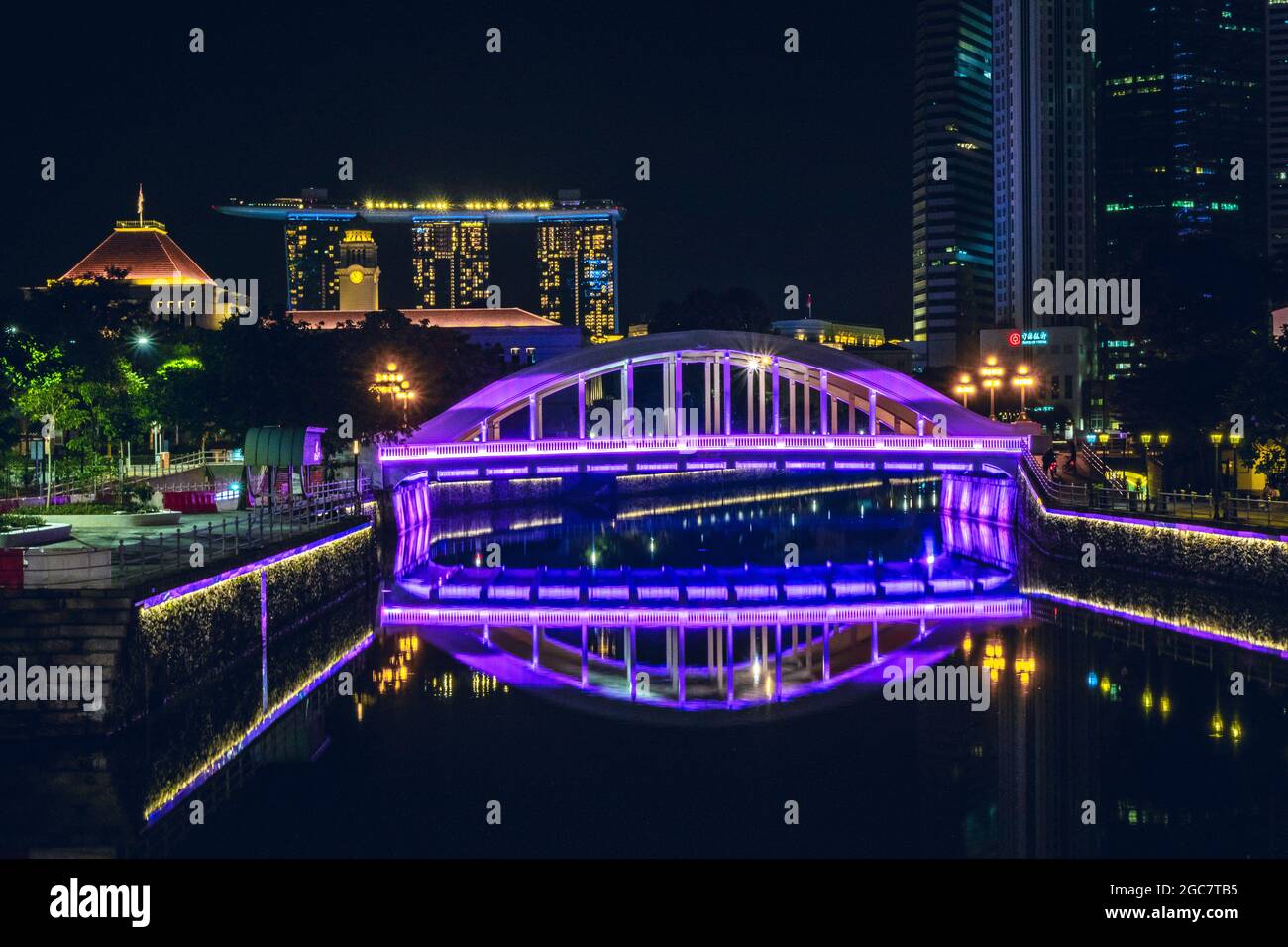 Scenic night view with clear calm water reflection of a vehicular box girder bridge across the Singapore River. Stock Photo