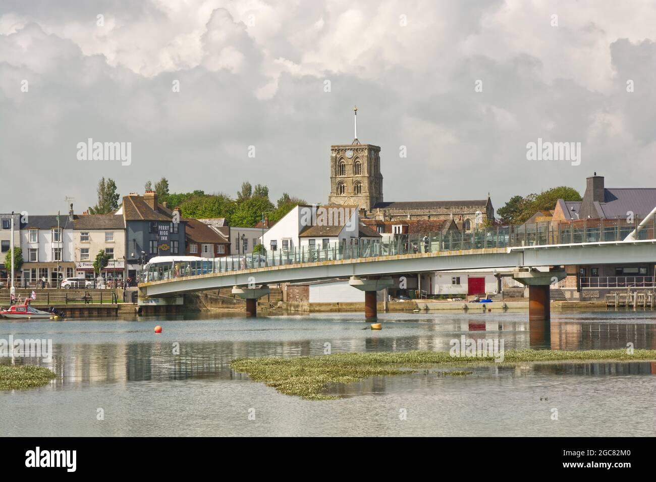 Footbridge over River Adur at Shoreham, West Sussex, England. With town behind and people walking around. Stock Photo