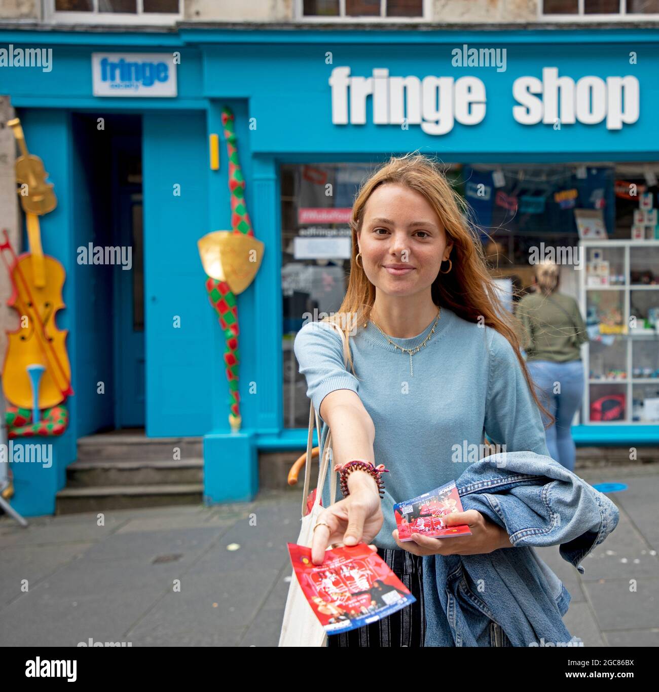 Edinburgh, Scotland, UK. 7th August 2021. A busier day for   second day of Edinburgh Fringe Festival in Royal Mile.Ember, one of the few people handing out flyers for a show, Theatre 19 Present: JOHN  theSpace@Sugeons Hall. Credit: Arch White/Alamy Live News. Stock Photo
