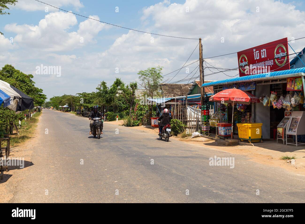 CAMBODIA - 28TH MARCH 2017: Rural  roads and streets in Cambodia near Siem Reap. The outside of shops and people can be seen. Stock Photo