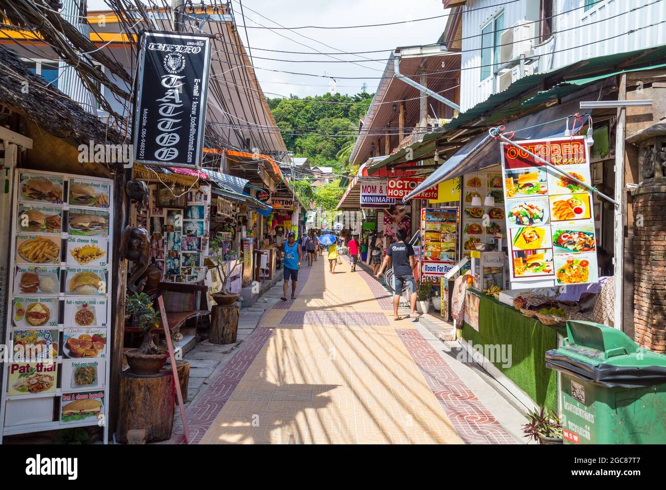 KO PHI PHI, THAILAND, 31ST MARCH 2017: Shops and streets on Ko Phi Phi island. Merchandise and people can be seen. Stock Photo