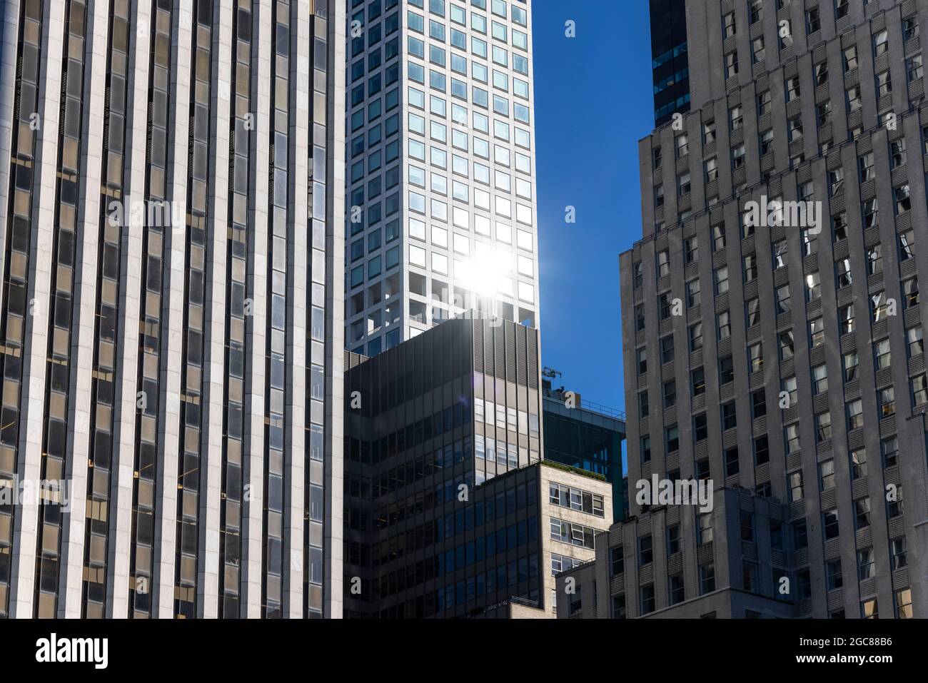 High-rise buildings stand among crowded buildings in Midtown Manhattan ...