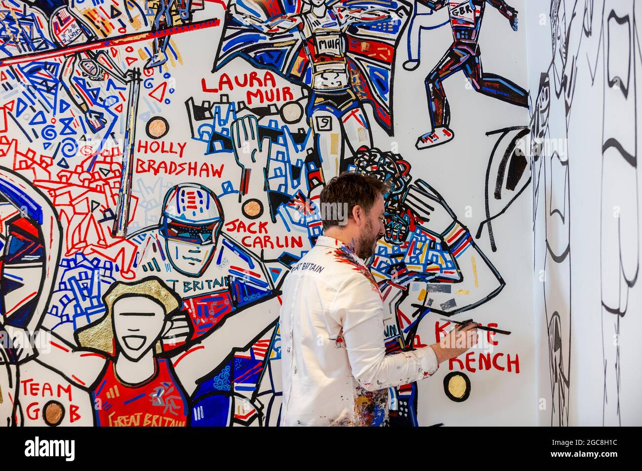 London, UK.  7 August 2021.  Ben Mosley, an action and expressionist painter, works on his wall mural focused on the achievement of Team Great Britain (GB) athletes at the Tokyo Olympics 2020.  Based at the pop-up Team GB Studio in Carnaby Street, he updates his mural daily with athletes' successes. The final day's events and closing ceremony are the work remaining. Team GB has become the first to adopt non-fungible tokens (NFTs) featuring the athletes’ previous achievements, which can be purchased through a dedicated store.  Credit: Stephen Chung / Alamy Live News Stock Photo