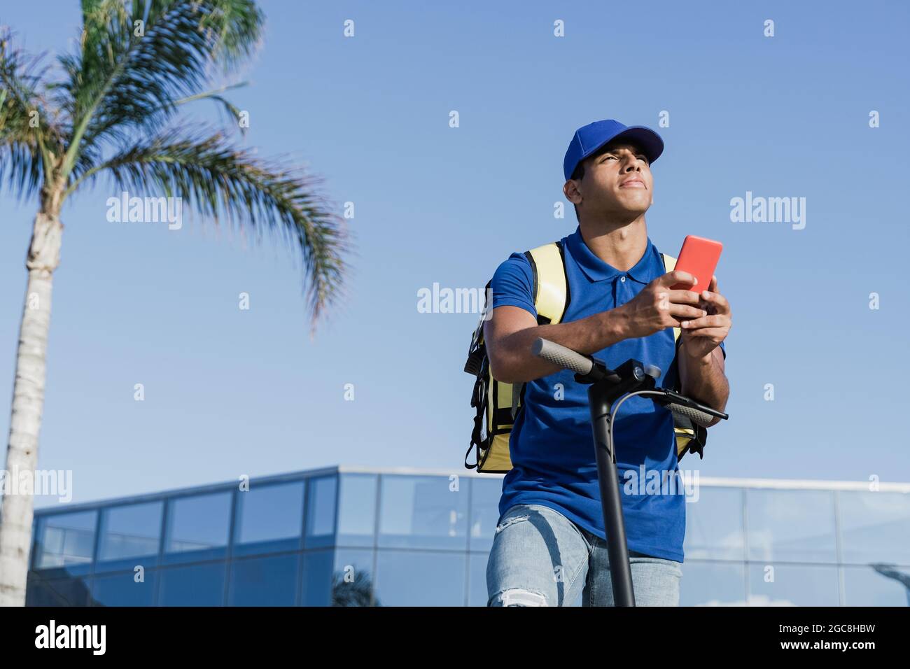 African delivery man browsing address on mobile phone map gps app for