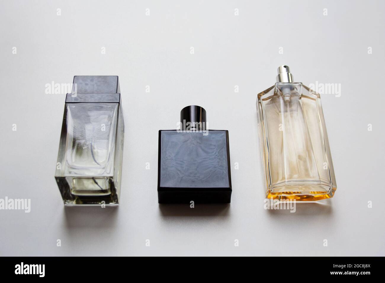 Three glass perfume bottles isolated on white background Stock Photo