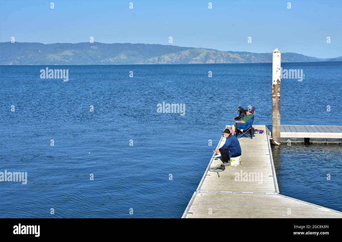 Men shore fishing at Clearlake California Stock Photo