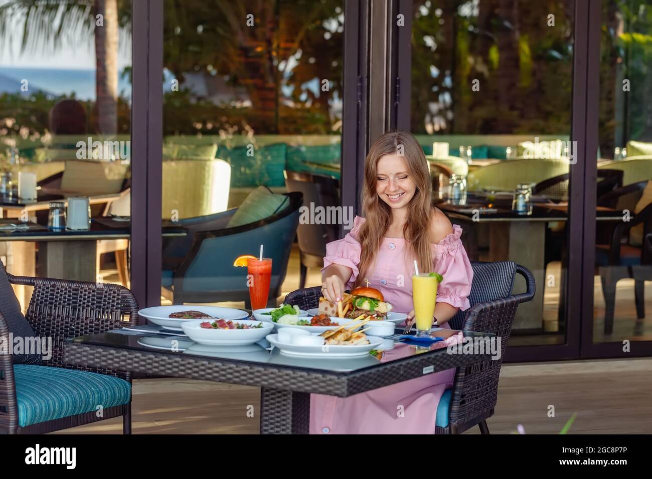 Woman Having Breakfast Relaxing Drinking Fresh Juice in Luxury Resort Stock Photo