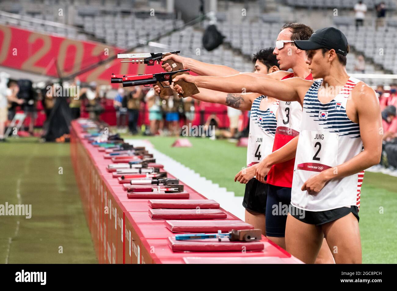 Czech athlete Jan Kuf, center, attends laser run shooting