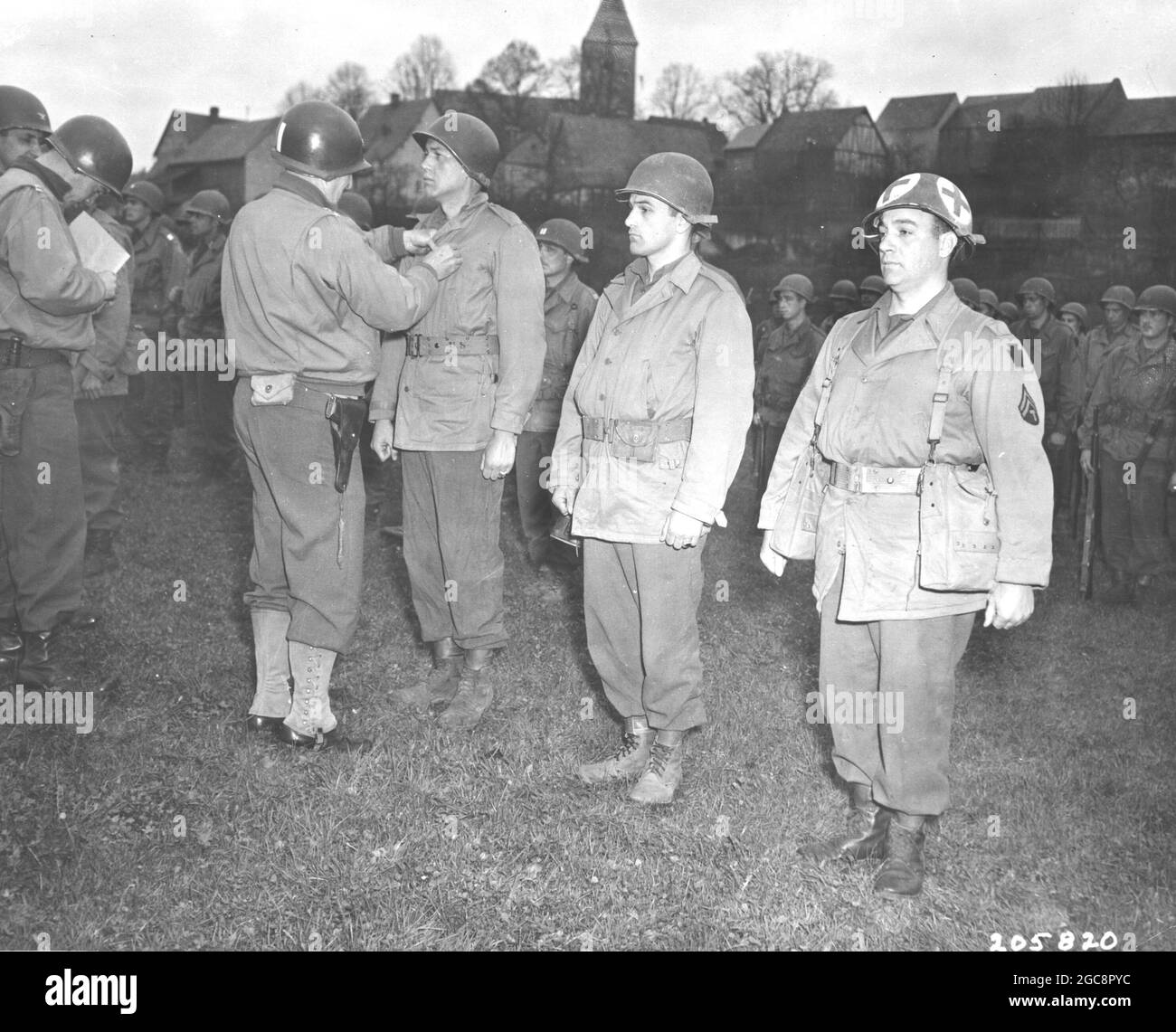 Lahr, Germany. Major General D. Cota, CG, 28th Division, U.S. First Army, Presents the Bronze Star Medal to L. to R., Cpl. John H. Reese of Brigham Ci Stock Photo